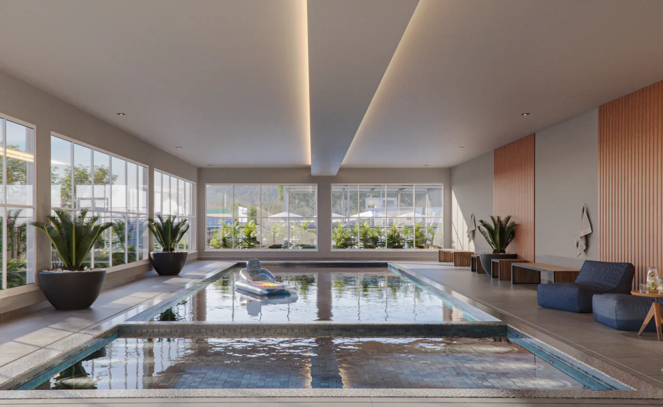 Piscina coberta e aquecida do Garden Club Residence II, com paredes de vidro e poltronas