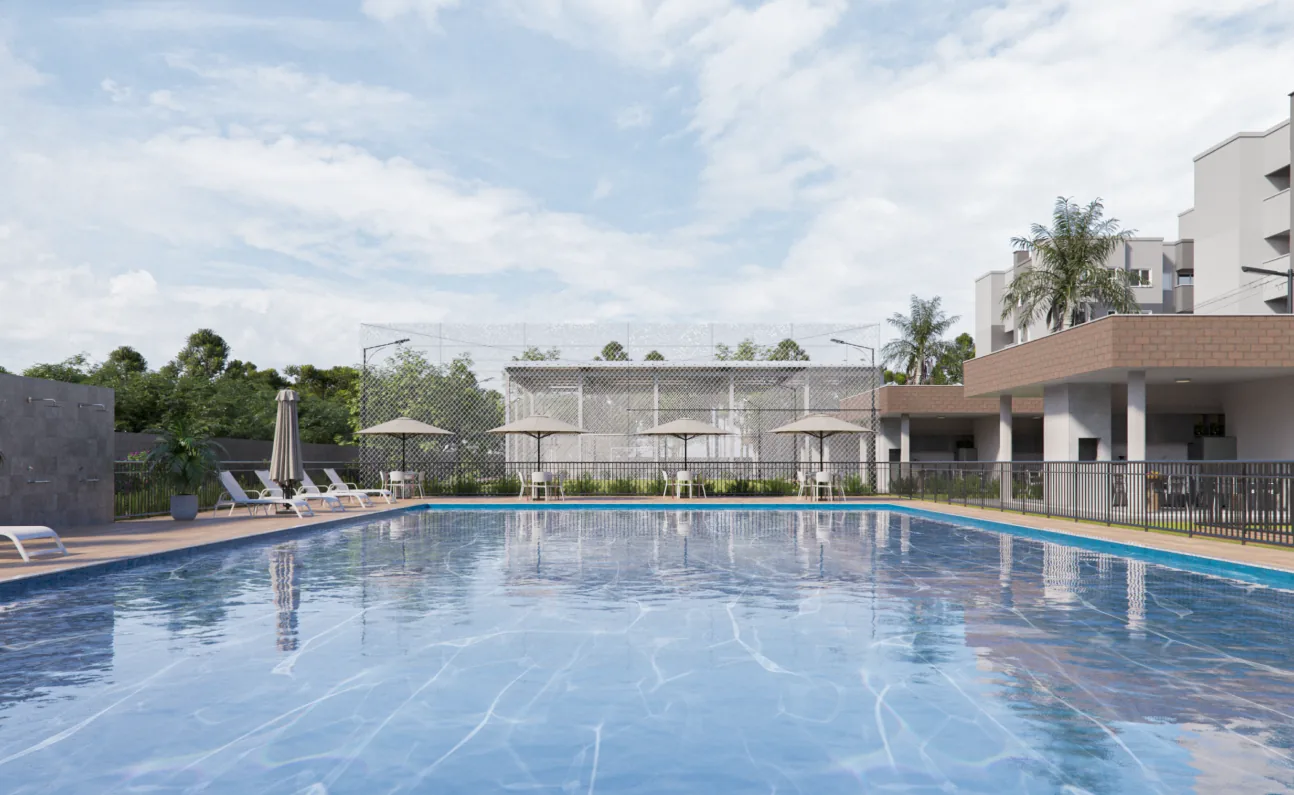 Piscina semiolímpica do Garden Club Residence II, com deck, espreguiçadeiras e a área gourmet ao fundo