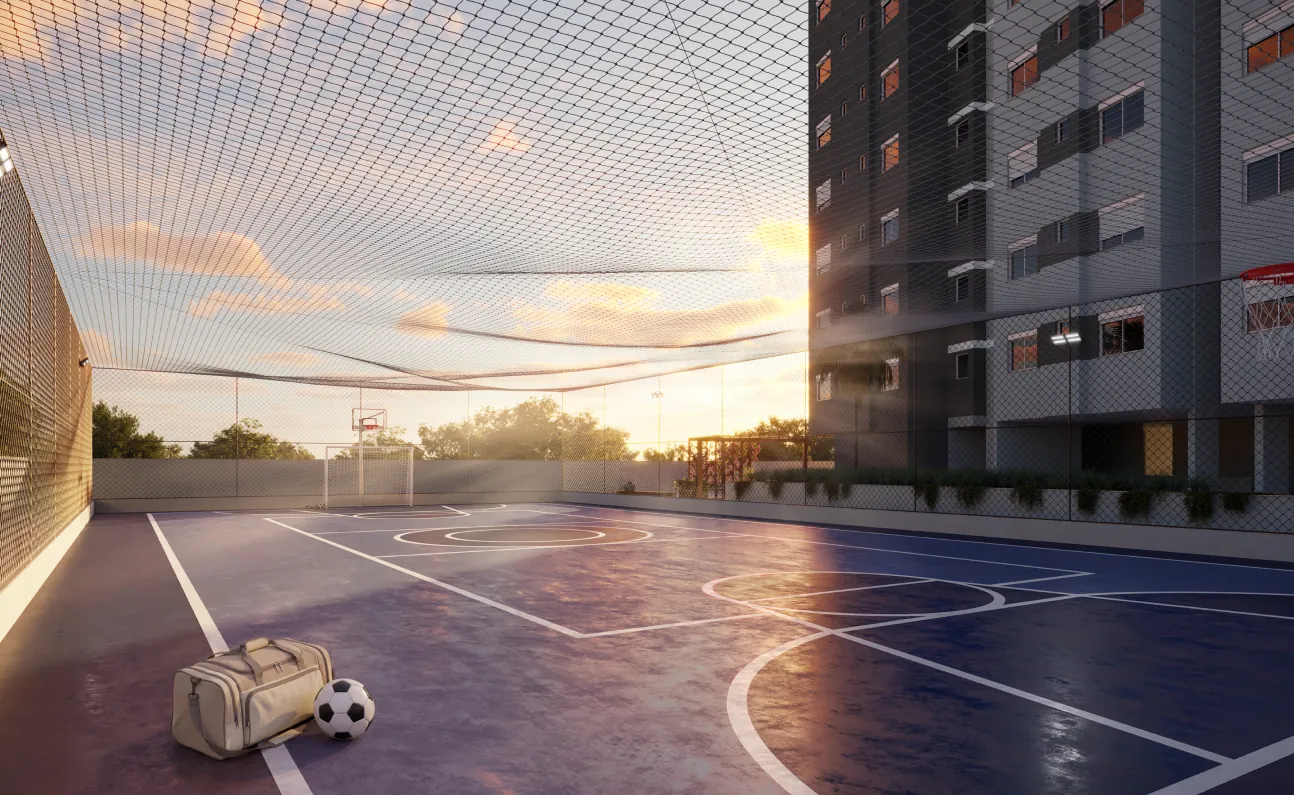 Quadra poliesportiva do Grand Life Residence ao pôr do sol, com piso azul e a torre ao lado