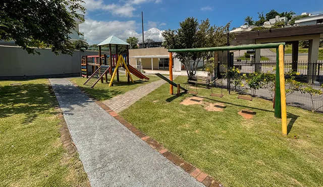 Playground infantil e área verde com pista de caminhada do condomínio Parque da Pedra em Palhoça/SC