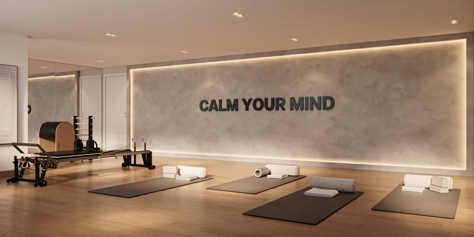 Sala de pilates e yoga do Self Residence, com aparelho de pilates, tapetes e o painel Calm Your Mind